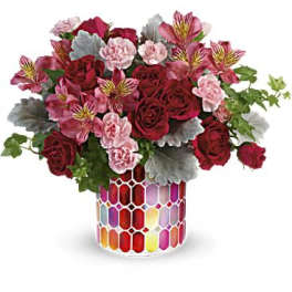 Bouquet of red roses and pink alstroemeria in a colorful mosaic vase
