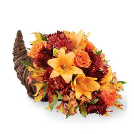 Cornucopia-style arrangement with orange roses and lilies