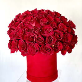 Large bouquet of red roses in a red hat box