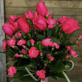 Pink roses and small pink flowers in a lavender vase