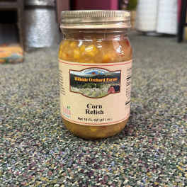 Jar of corn relish with a metal lid on carpet