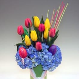Bouquet of yellow and pink tulips in a bunny-decorated vase