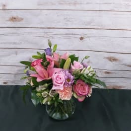Pink and purple mixed bouquet in a glass vase