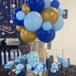 Blue and gold balloon cluster with teddy bears and gift boxes