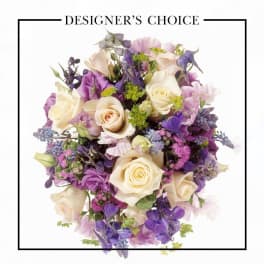 Bouquet of cream roses and purple flowers with mixed blooms