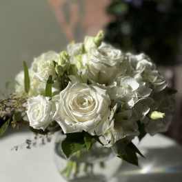 White rose bouquet in a clear glass vase