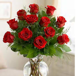 Red roses arranged in a clear glass vase