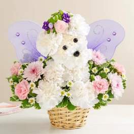 Teddy bear floral arrangement in a basket with purple wings