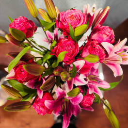 Bouquet of hot pink roses and pink-and-white lilies