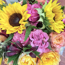Bouquet of yellow sunflowers and pink roses