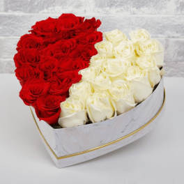 Heart-shaped box filled with red and white roses