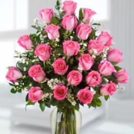 Pink roses arranged in a clear glass vase