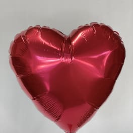 Red heart-shaped foil balloon on a stick