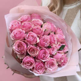 Bouquet of pink roses wrapped in pale pink paper