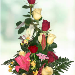 Tall bouquet of red and yellow roses with pink lilies and a Valentine pick