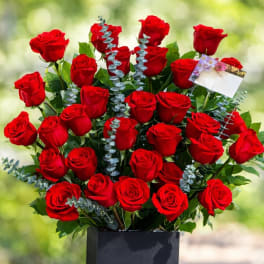 Bouquet of red roses in a black box vase