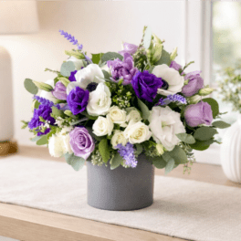 Purple and white bouquet in a gray vase