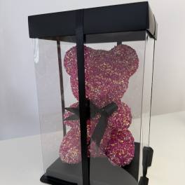 Pink glitter teddy bear in a clear gift box with a black ribbon