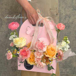 Pink gift box bouquet with roses, carnations, and daisies