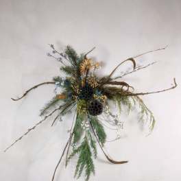 Asymmetrical wall arrangement with pine branches, twigs, and dried seed pods