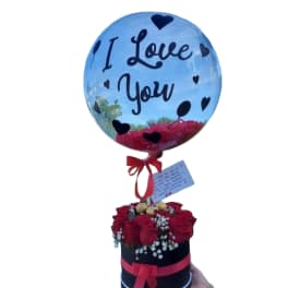 Balloon with "I Love You" above a box of red roses