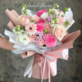Hand-tied bouquet of pink and white roses with gerbera daisies