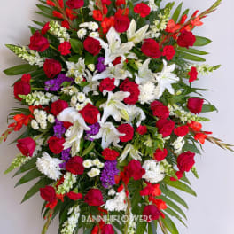 Large standing spray of red, white, and purple flowers
