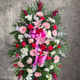 Standing floral spray with pink lilies, roses, and gerbera daisies