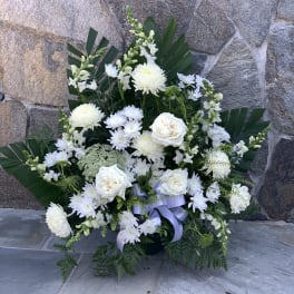 White floral arrangement with roses and chrysanthemums in a vase