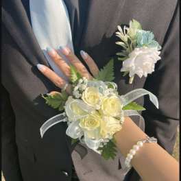 Corsage and boutonniere with pale yellow and white roses