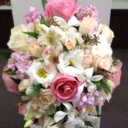 Cascade bouquet of pink and white flowers with trailing blooms