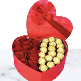 Heart-shaped red gift box with red roses and gold-wrapped chocolates
