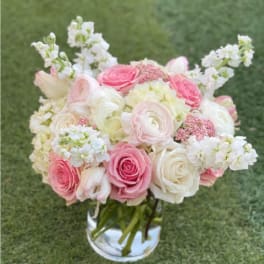 Pink and white bouquet in a clear glass vase