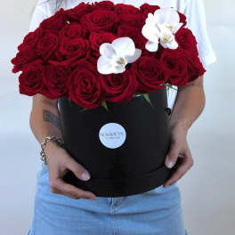 Large bouquet of red roses with two white orchids in a black box