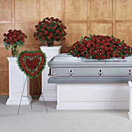 Red rose funeral casket spray with matching standing arrangements