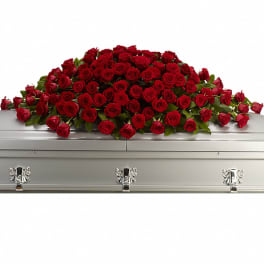Red rose casket spray on a silver casket