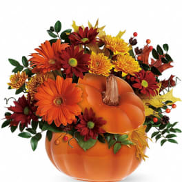 Pumpkin-shaped vase with orange and red flowers