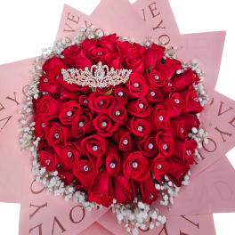Bouquet of red roses with baby’s breath and a jeweled tiara topper