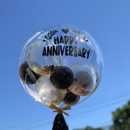 Clear balloon with "Happy Anniversary" text and smaller balloons inside