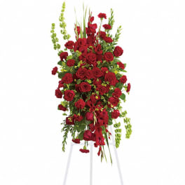 Tall red rose and carnation standing spray on a white easel
