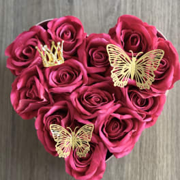 Heart-shaped bouquet of pink roses with gold butterfly and crown decorations