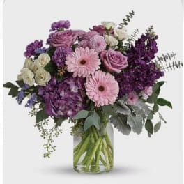 Pink and purple mixed bouquet in a clear glass vase