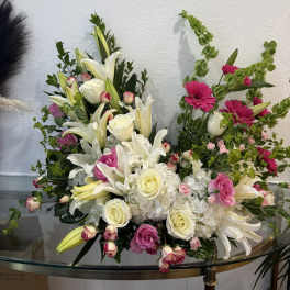 Large floral arrangement with white lilies, roses, and pink blooms