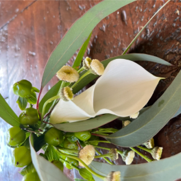 White calla lilies with green berries and long leaves