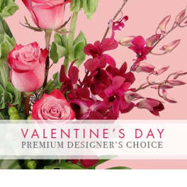 Pink roses and magenta orchids on a pink background with Valentine’s Day text