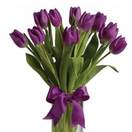 Tall bunch of purple tulips in a clear glass vase tied with a matching purple ribbon