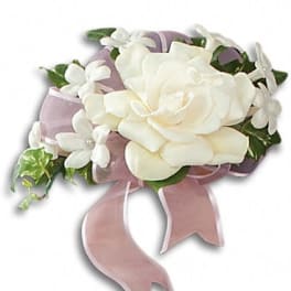 White rose corsage with small white flowers and pink ribbon
