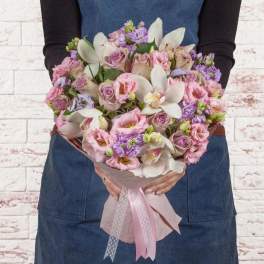 Handheld bouquet of pink roses and white orchids with a pink ribbon wrap