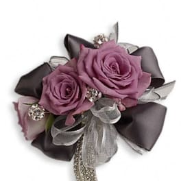 Purple rose corsage with silver ribbon and rhinestone accents