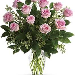 Pink roses arranged in a clear glass vase